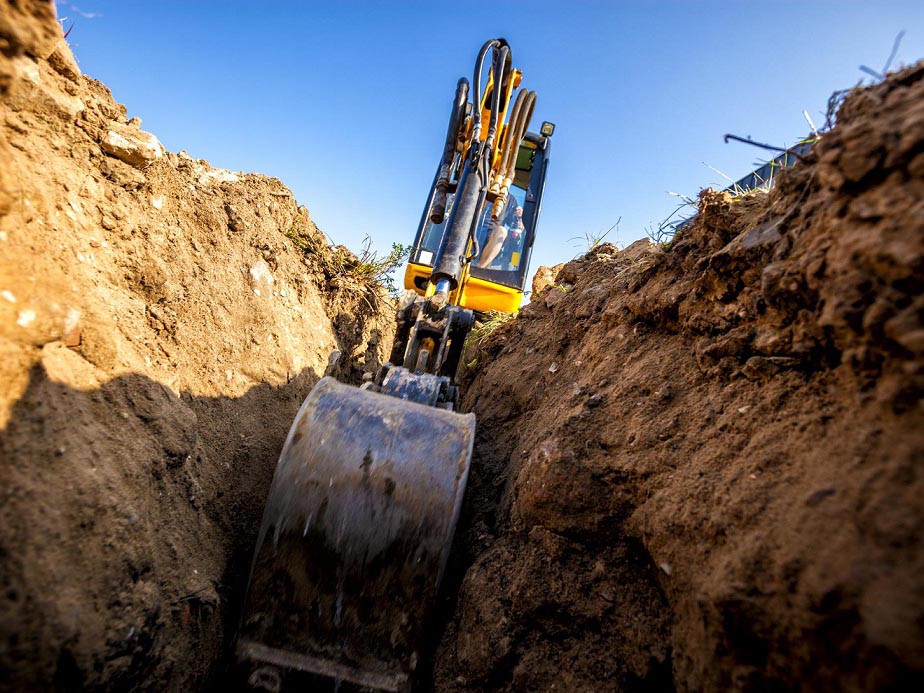 Excavator digs the foundation for the house